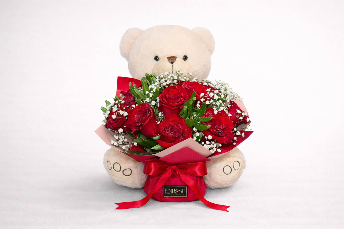 Teddy bear with a bouquet of 10 red roses.