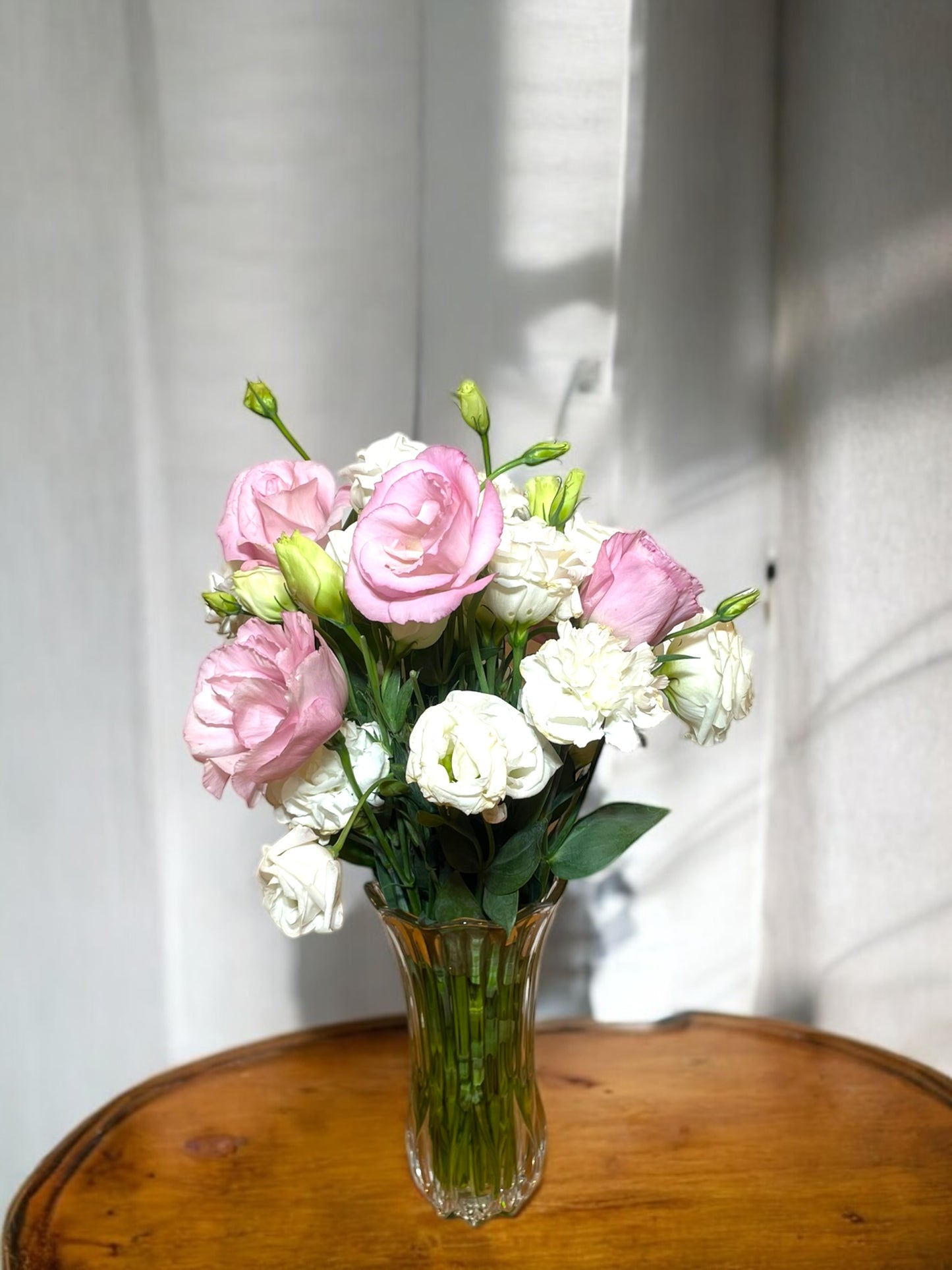Arrangement of Pink and White Lisianthus in a Glass Vase