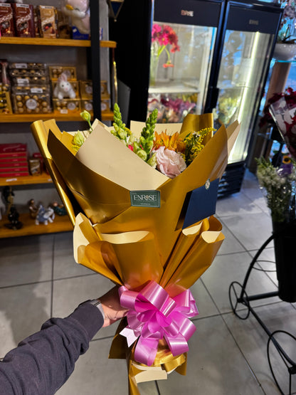 A vibrant bouquet of sunflowers and mixed flowers.
