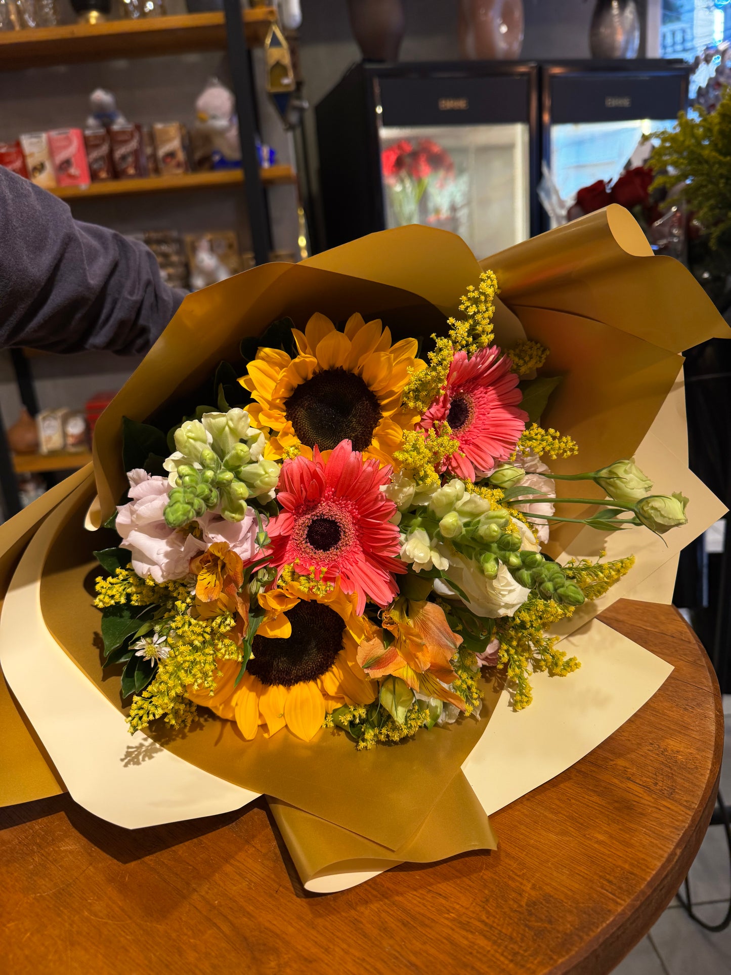 A vibrant bouquet of sunflowers and mixed flowers.