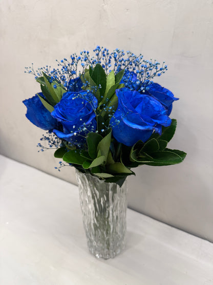 Blue masculine arrangement with glass vase.