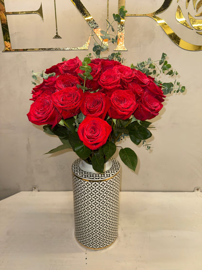 Classic arrangement of red roses in a porcelain vase.