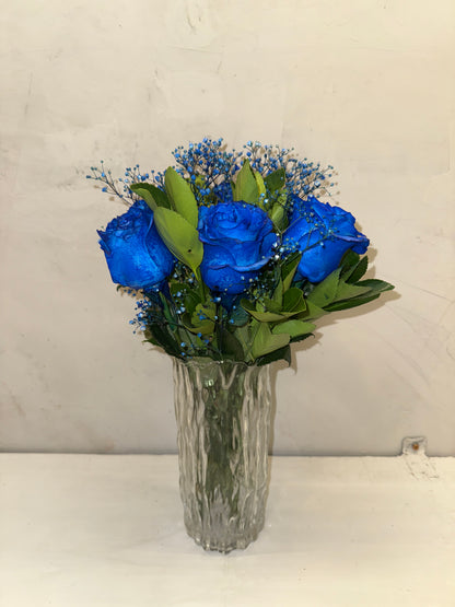 Blue masculine arrangement with glass vase.