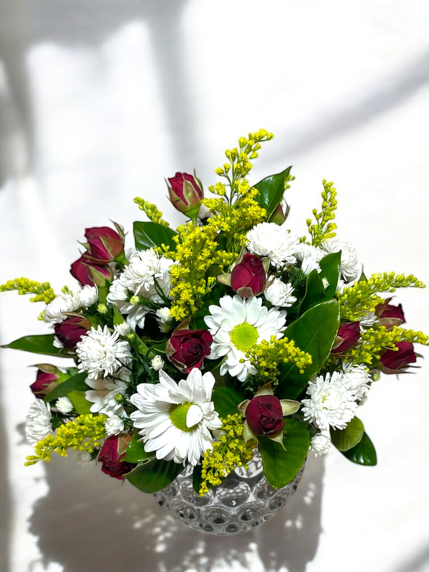 Arrangement of Mini Roses and Daisies in a Glass Vase