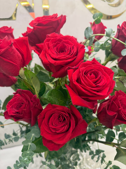 Classic arrangement with 50 Colombian red roses and a crystal vase.