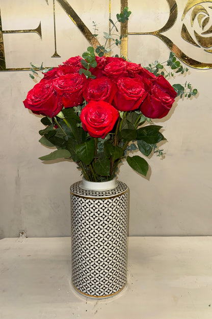 Classic arrangement of red roses in a porcelain vase.
