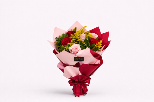An elegant bouquet with red and light pink roses.